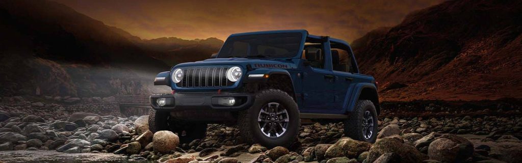 Jeep Wrangler standing in a rocky region during sunset.